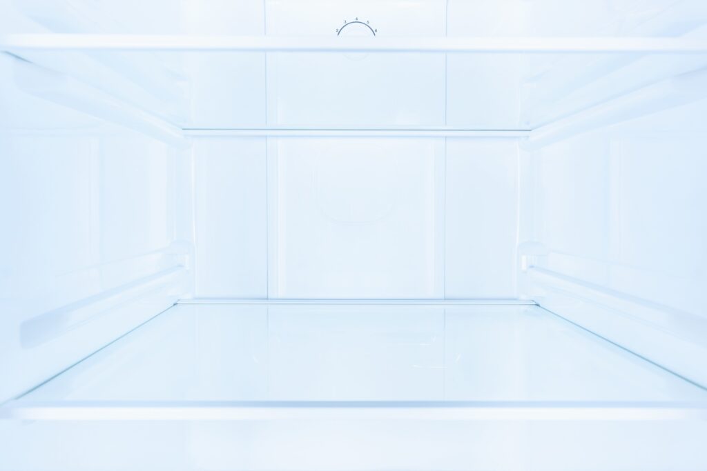 shelves in empty open white fridge